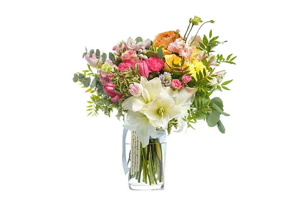 Colorful graduation bouquet with lilies, roses, and bright seasonal blooms in a glass vase