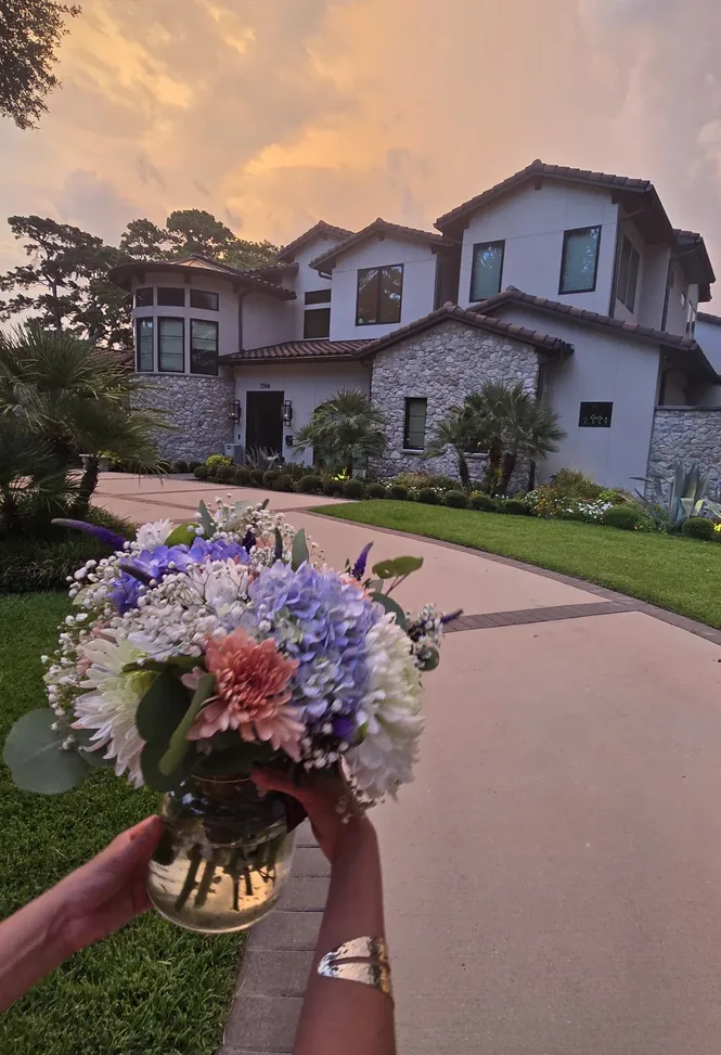 Lola in Bloom hand-delivered bouquet in front of a Houston Heights home